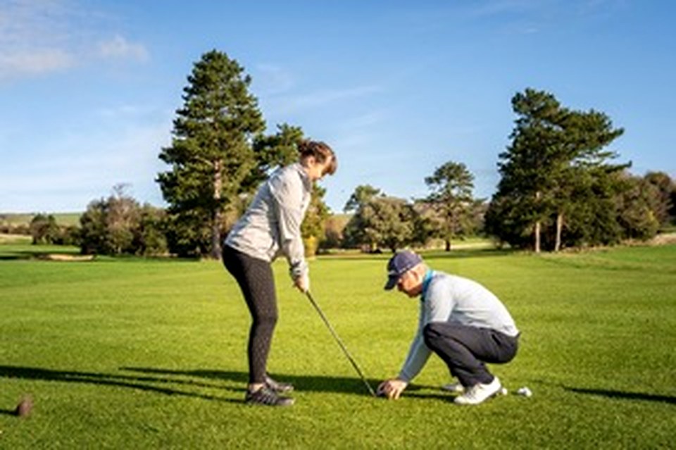Simon coaching a guest on the tee